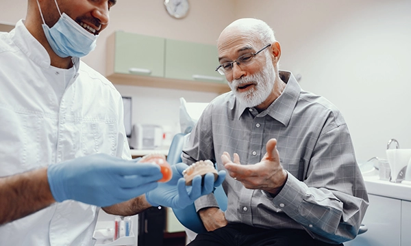 Person getting denture and partial information from dentist